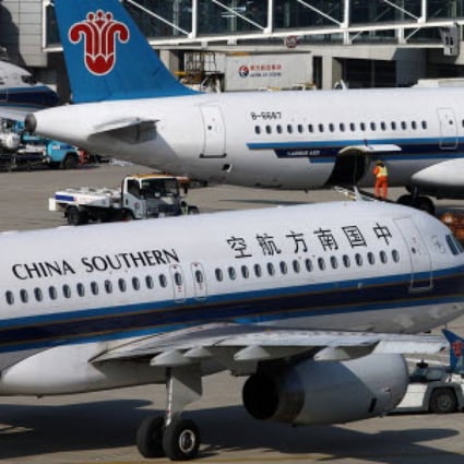China Southern aircraft are parked at Pudong airport in Shanghai. More than 100 flights were either delayed or cancelled at Pudong and Hongqiao airports today. Photo: Bloomberg