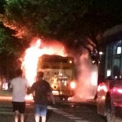 The bus is engulfed in flames near Nandunhe Bus Station on Guangzhou Avenue last night. Photo: SCMP Pictures