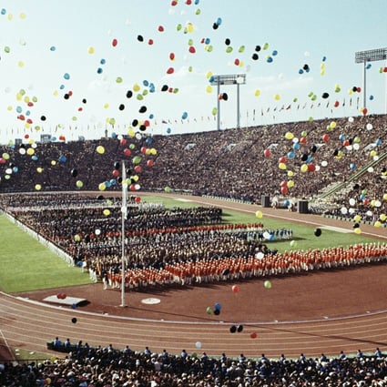Balloons fly over competitors and spectators during the opening ceremony of the 1964 Summer Olympics at the National Stadium in Tokyo. The event marked Japan's rise from humiliating defeat in the second world war to emerge as a major international player. Photo: AP