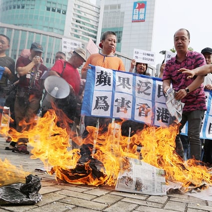 Protesters burn newspapers outside the Apple Daily headquarters in Tseung Kwan O. Photo: Sam Tsang