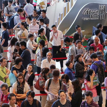 Some of the more than 10,000 prospective apartment buyers wait at the Mont Vert sales office in Hung Hom. Photo: Felix Wong