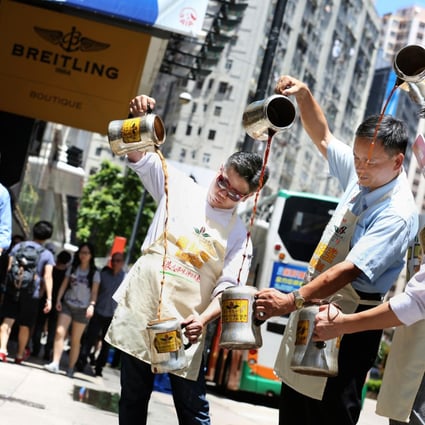 Masters of milk tea (from left) Chan Wai-chung, Leung Tak-chau and Yu Chun-wah show off their skills in Causeway Bay to promote next month's contest. Photo: Nora Tam