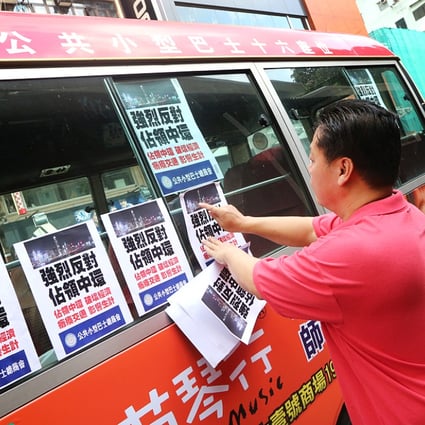 Minibus drivers attach anti-Occupy posters to their vehicles during Tuesday's protest in Mong Kok. Photo: David Wong