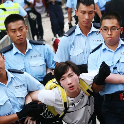 A protester is carried away by police during a protest sit-in last month. Photo: David Wong