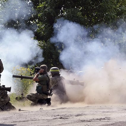Ukrainian soldiers fire on the position of pro-Russian separatists near Lugansk on Friday. Photo: EPA