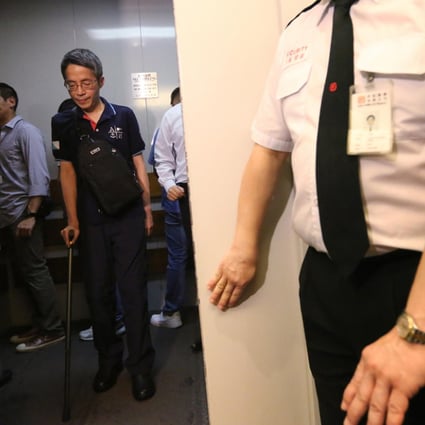 Kevin Lau relies on a crutch as he returns to the offices of Ming Pao for the first time since the attack in February. Photo: Felix Wong