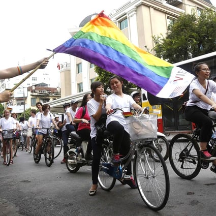 A rainbow flag is waved as the parade passes. Photo: Reuters
