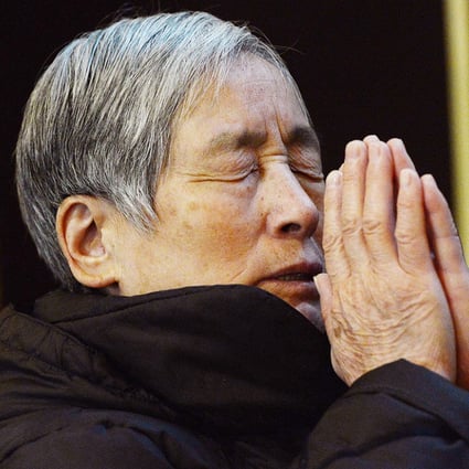 A woman prays at a cathedral in Beijing. Experts estimate that there were as many as 12 million Catholics on the mainland as of last year, with about half of the congregations under a state-sanctioned association. The rest belong to non-sanctioned or so-called 'underground' churches. Photo: AFP