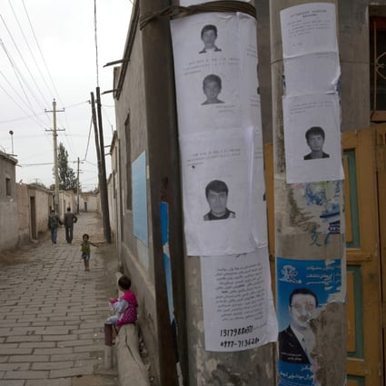 Wanted posters put up in Aksu, Xinjiang, of men suspected to be involved in terrorist attacks. Photo: AP