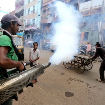 A sanitation worker fumigates a neighbourhood in Bhopal, India, where dengue fever has also been a major concern in the past few weeks. Photo: Xinhua