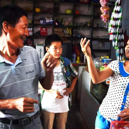 Vietnamese bride Vu Thi Hong Thuy, 21, chats with customers at the shop where she works in Weijian village in Henan. Photo: AFP