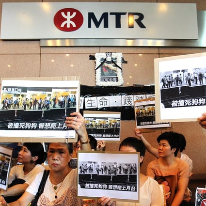 Protesters outside MTR headquarters held aloft images of the stray dog trying to get back onto the platform. Photo: May Tse