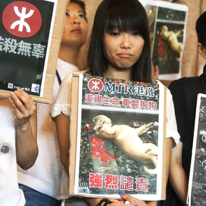 A group of protesters criticise the MTR for its lack of concern for life. Photo: EPA