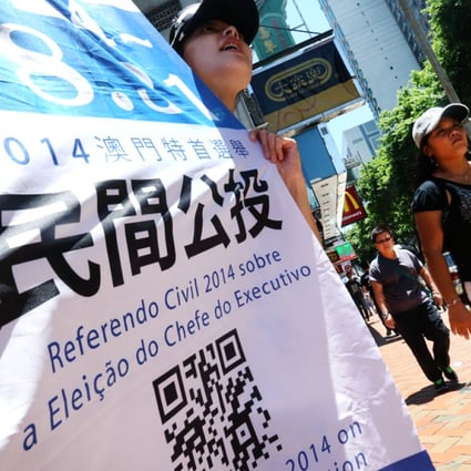 Concern group hold banner to urge people to vote in an civil referendum in Macau. Photo: K.Y. Cheng
