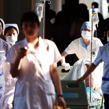 Doctors and nurses rush a victim of a factory explosion for treatment at a hospital in Kunshan. Photo: AFP