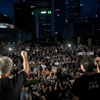Leaders of the Occupy Central movement address a crowd gathered to protest Beijing's decision on the 2017 election on Sunday. Photo: AFP