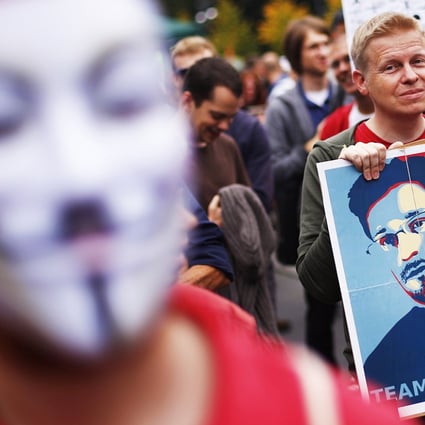 A man holds a placard with a portrait of Edward Snowden during a "Freedom instead of Fear" protest calling for the protection of digital data privacy and the reigning in of digital surveillance practices, in Berlin on August 30, 2014. Photo: Reuters