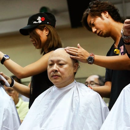 (From left) Dr Chan Kin-man, Benny Tai Yiu-ting and Reverend Chu Yiu-ming have their heads shaved on Tuesday. Photo: Sam Tsang 