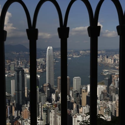 The skyline of Hong Kong is seen through a fence at the Peak in Hong Kong September 10, 2014. Photo: Reuters