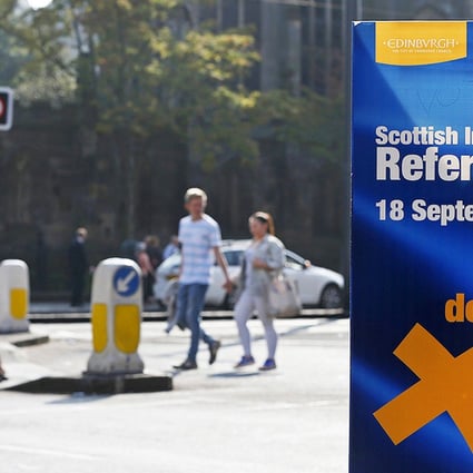Pedestrians pass a banner urging them to vote in the independence referendum on Princess Street in Edinburgh, Scotland on Thursday. Photo: Reuters