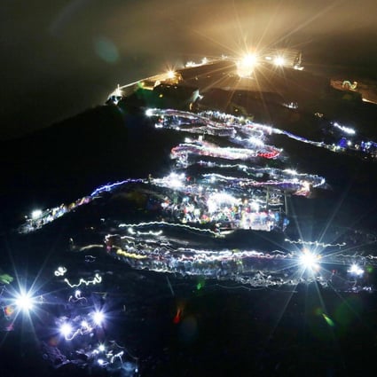 Flashlights trace a line of climbers hiking to Fuji's summit. Photo: AFP