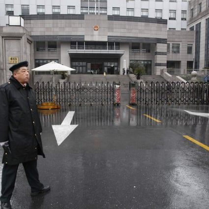 A security guard stands in front of the Shanghai Pudong New Area People's Court in Shanghai. Photo: Reuters