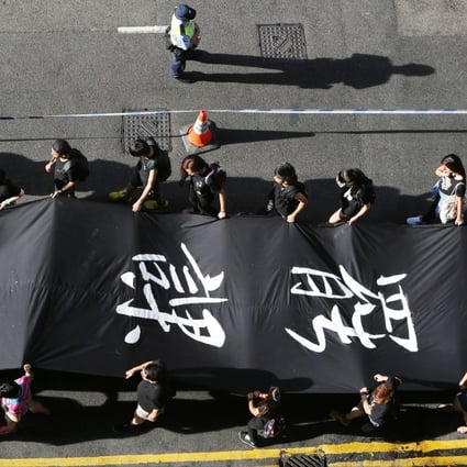 Protestors hold Black Cloth match to Chater Road from Causeway Bay during Occupy Central with Love and Peace conduct a "Black Cloth March" on Sunday. Photo: Felix Wong
