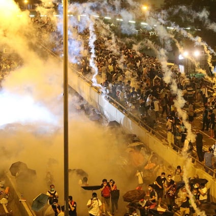Police in riot gear fire tear gas at Occupy Central protesters in Connaught Road Central, Admiralty. Yesterday was the first time gas had been deployed by Hong Kong police since 2005. Photo: K.Y. Cheng