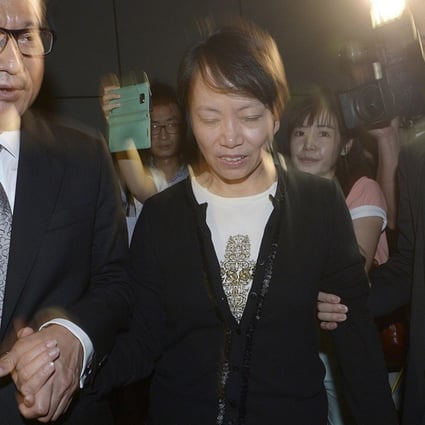 Development Secretary Paul Chan leaves court with his wife Frieda Hui and their son Chan Tian-hsing. Photo: Edward Wong