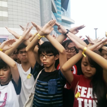 Hong Kong students protesting at the flag ceremony in Golden Bauhinia Square. Photo: Chris Lau 