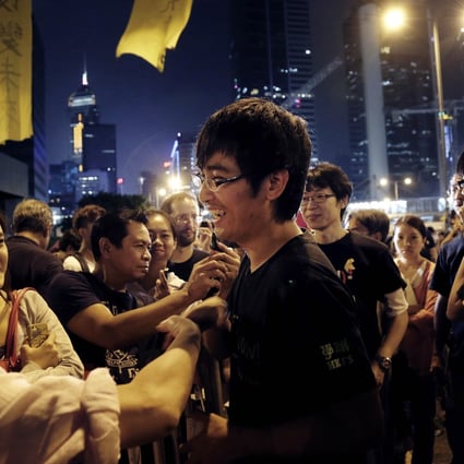 Pro-democracy supporters encourage student leader Alex Chow at a rally on Monday. Photo: AP