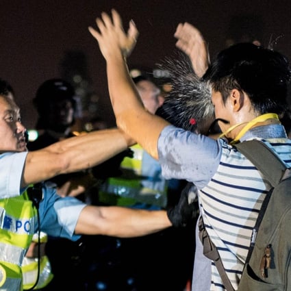 An officer uses pepper spray. Photo: AFP