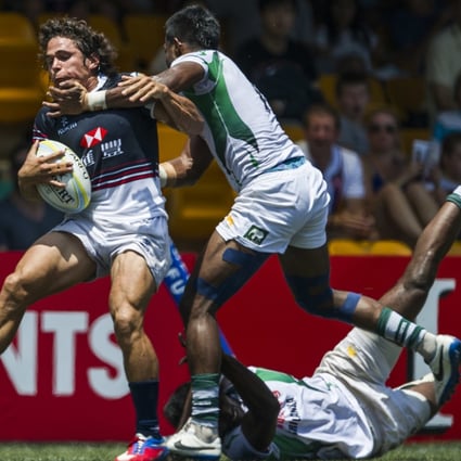 Rowan Varty runs into trouble against Sri Lanka in the Hong Kong Asian Sevens men’s semi-finals, but the hosts powered through and took maximum points from the first stop on the 2014 Asian Sevens Series. Photo: Power of Sport Images for HKRFU
