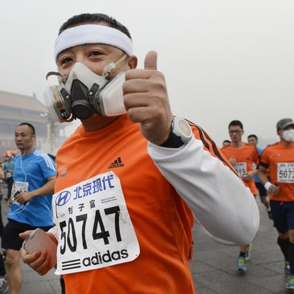 Runners leave Tiananmen Square during yesterday's Beijing marathon - despite the government warning the air quality was unsuitable for outdoor activities. Photo: Reuters