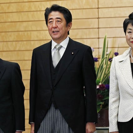 Shinzo Abe (centre) poses with Yoichi Miyazawa (left) and Yoko Kamikawa. Photo: Reuters