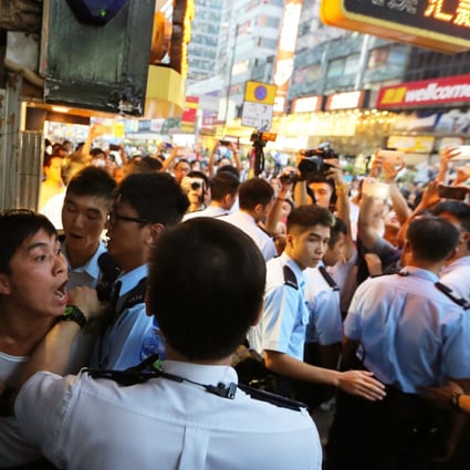 Police arrest an activist in Mong Kok during Occupy Central movement. Photo: Sam Tsang