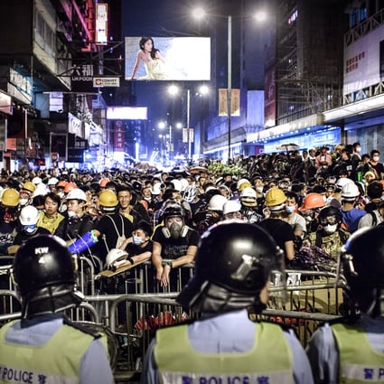 Riot police and protesters face off in Mong Kok on October 19. Photo: AFP