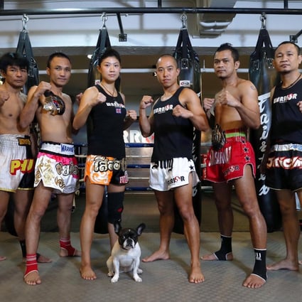 Warrior Muay Thai trainers (from left) Bird, Phut, Nom, Purcell Tong, co-founder Billy Tam, Tam, Bhurm and Keng and Maya, the gym's mascot. Photo: K.Y. Cheng