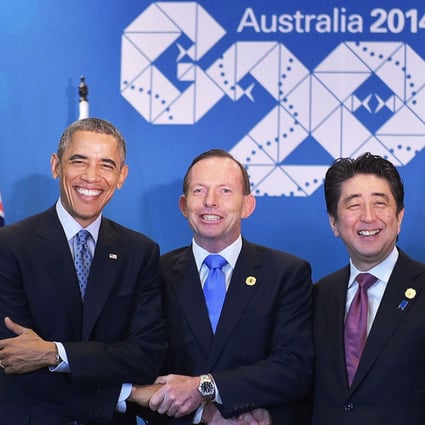 Barack Obama, Tony Abbott and Shinzo Abe seal a deal to strengthen military ties between their countries. Photo: AFP