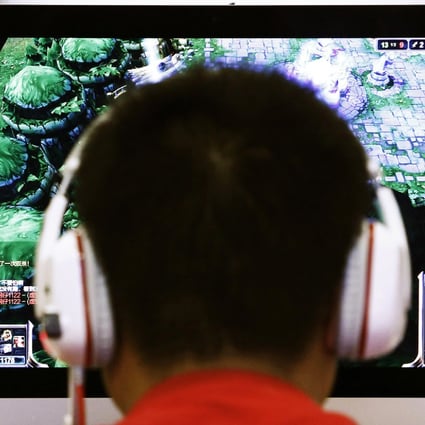 A man plays a computer game at an internet cafe in Beijing. Photo: Reuters