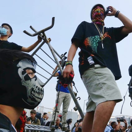 Protesters stand on the barricades. Photo: Sam Tsang