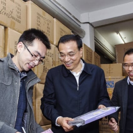 Chinese Premier Li Keqiang (centre) visits an e-commerce store in Qingyanliu village. Photo: SCMP Pictures