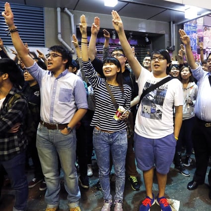 Protesters imitate a three-finger salute from movie "The Hunger Games", during a rally at Mong Kok. Photo: Reuters