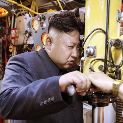 North Korean leader Kim Jong-un peers through a periscope of a submarine during an inspection of the Korean People's Army Navan Unit in June. Photo: Reuters