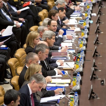 US Secretary of State John Kerry (front centre) chairs a round-table meeting at Nato headquarters. Photo: AP
