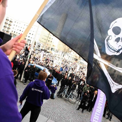 A supporter of file-sharing hub The Pirate Bay, waves a Jolly Roger flag during a demonstration in Stockholm in 2009. Photo: Reuters