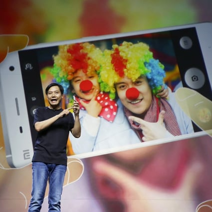 Lei Jun, founder and CEO of China's mobile company Xiaomi, demonstrates the new features of the new Xiaomi Phone 4 at its launching ceremony in Beijing. Photo: Reuters
