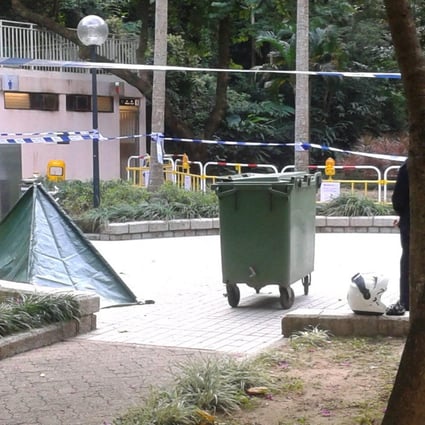 A green tent covers a woman's dead body. Photo: SCMP 