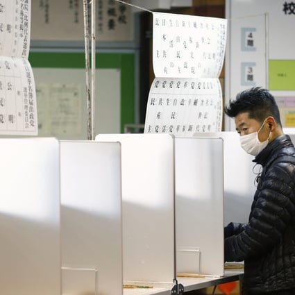 A man fills his ballot paper to vote in a lower house parliamentary election in Tokyo. Photo: Reuters