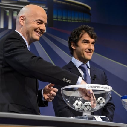 Uefa general secretary Gianni Infantino chooses a ball next to the Uefa ambassador, Karl-Heinz Riedle, at the draw. Photo: AFP